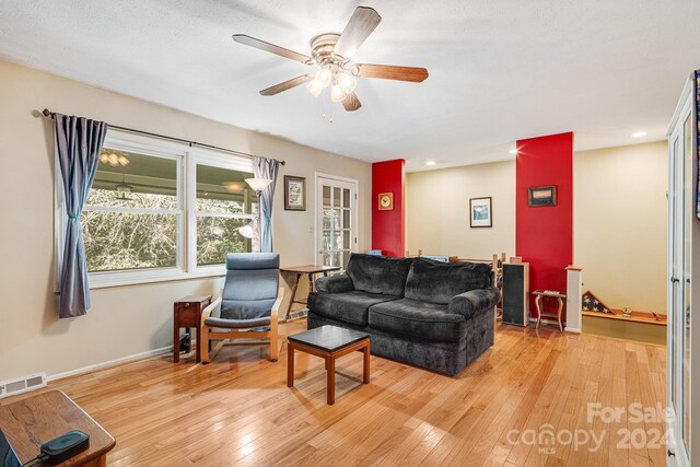 living room with ceiling fan and light wood-type flooring