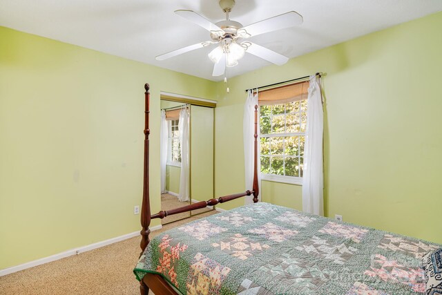 carpeted bedroom with ceiling fan and a closet