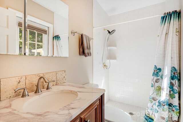 bathroom with a shower with shower curtain, toilet, and vanity