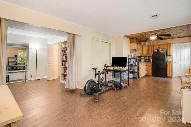 exercise area featuring wood ceiling, hardwood / wood-style floors, and ceiling fan