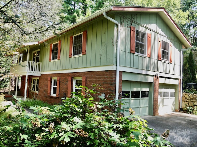 view of front facade with a garage and a balcony