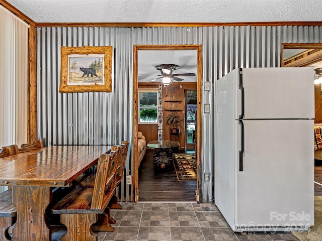 dining room with ceiling fan, tile patterned flooring, and a textured ceiling