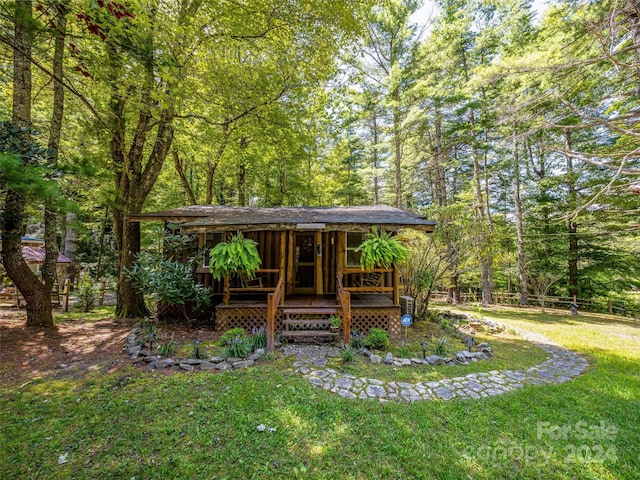 view of yard with a view of trees and a porch