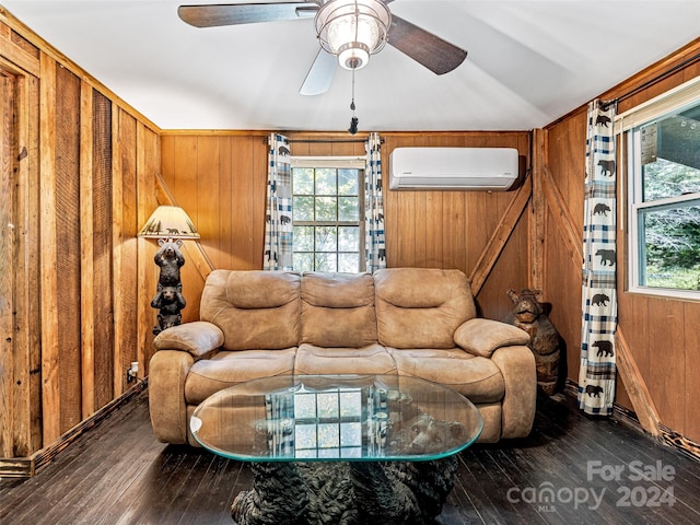 living room featuring ceiling fan, dark wood-type flooring, a wall unit AC, and wood walls