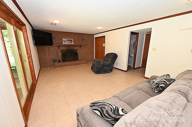 living room with ornamental molding, a brick fireplace, and a textured ceiling