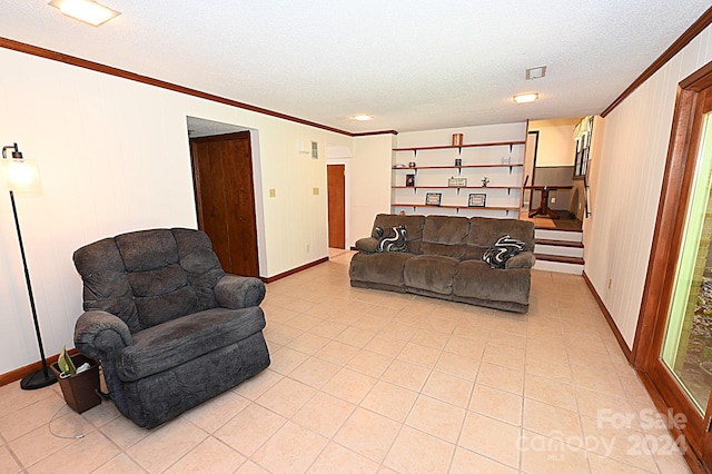 living area with ornamental molding, stairway, a textured ceiling, and light tile patterned floors