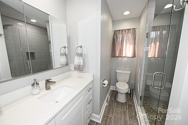 full bath featuring baseboards, toilet, a shower stall, and vanity