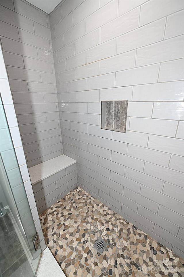 bathroom with tiled shower