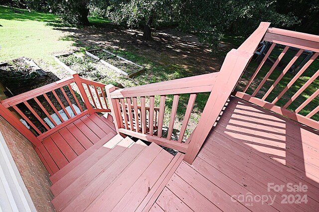 wooden terrace featuring a yard