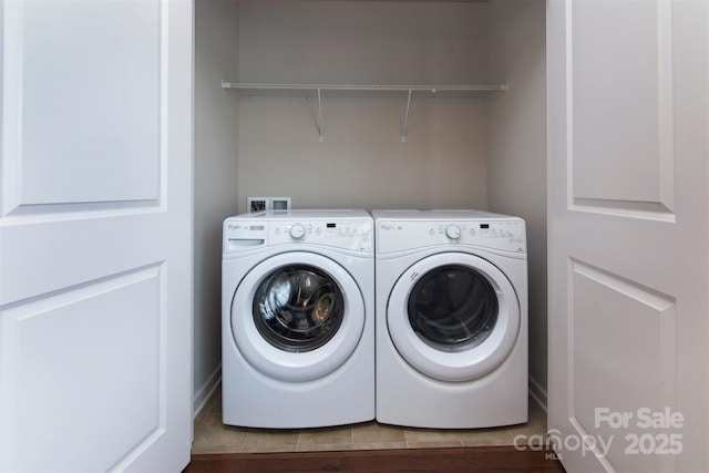 clothes washing area with washing machine and dryer