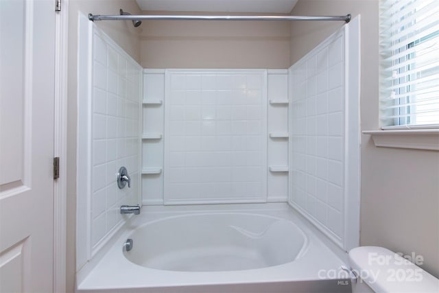 bathroom with shower / tub combination and toilet