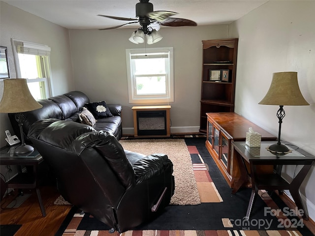 living room featuring ceiling fan and a healthy amount of sunlight