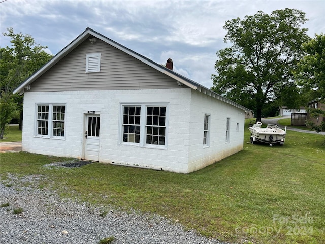 view of home's exterior with a lawn