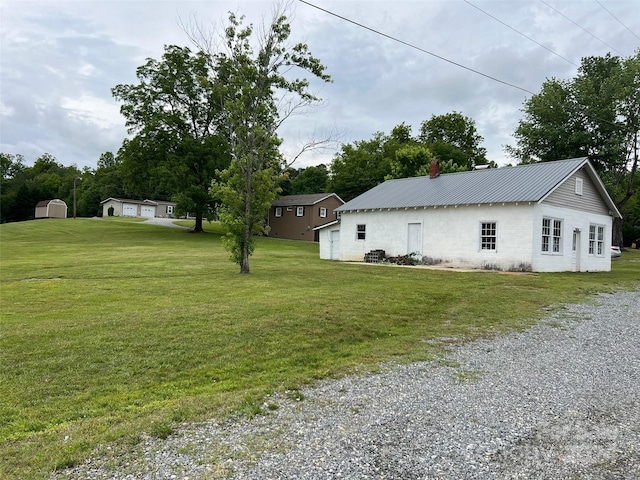 view of home's exterior with an outdoor structure and a lawn