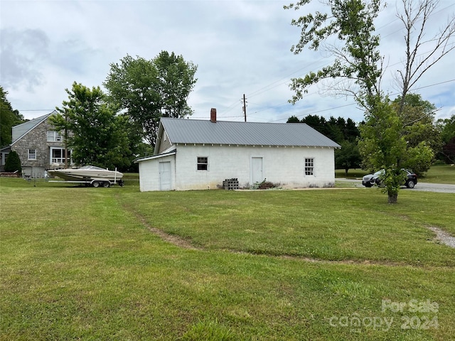 view of property exterior with a yard