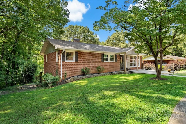 ranch-style house with a front yard and a patio