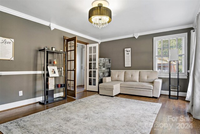 living room featuring dark hardwood / wood-style flooring and crown molding