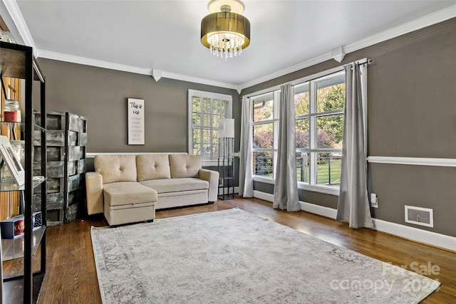 unfurnished living room with ornamental molding, wood finished floors, and a wealth of natural light