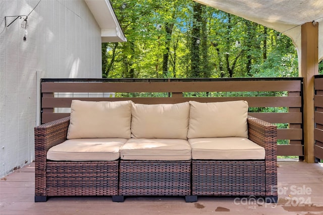 wooden terrace with outdoor lounge area