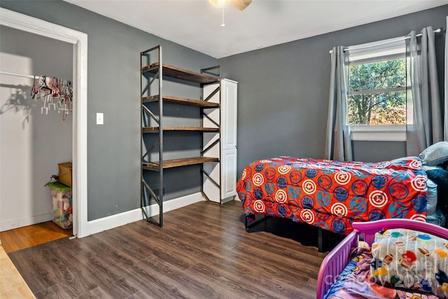 bedroom featuring dark hardwood / wood-style flooring and ceiling fan