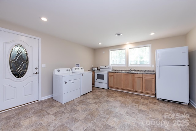 washroom with washer and clothes dryer and sink