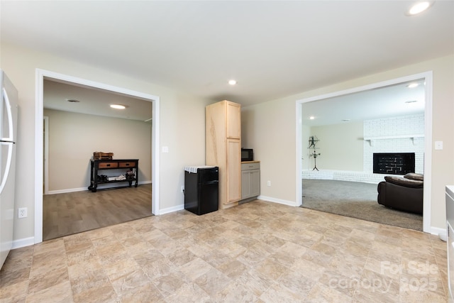 living room featuring a brick fireplace