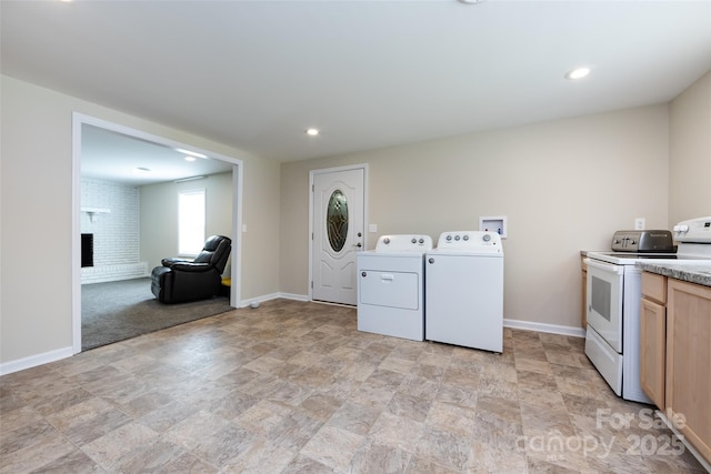 washroom with a fireplace and washer and clothes dryer