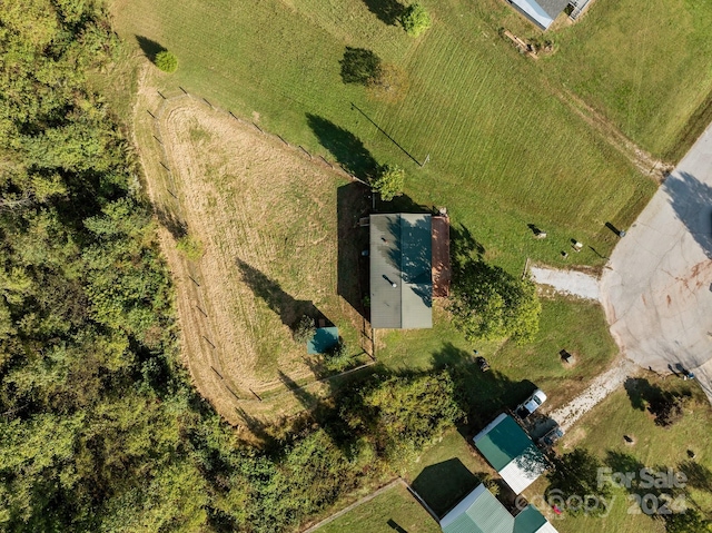 birds eye view of property with a rural view