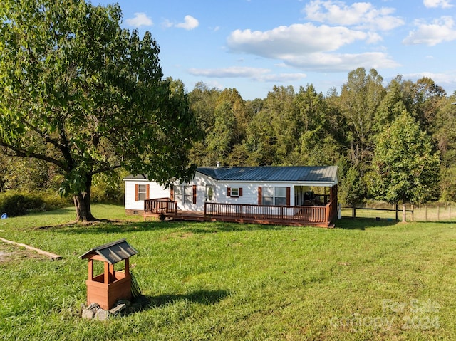 back of property featuring a deck and a yard