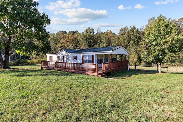 view of front of home with a front lawn and a deck