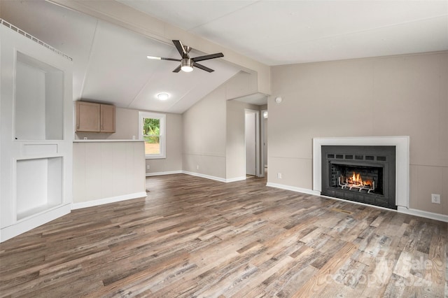 unfurnished living room with ceiling fan, dark hardwood / wood-style flooring, and vaulted ceiling