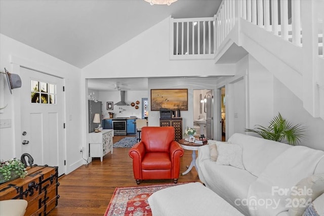 living room featuring a high ceiling, dark hardwood / wood-style flooring, and ceiling fan