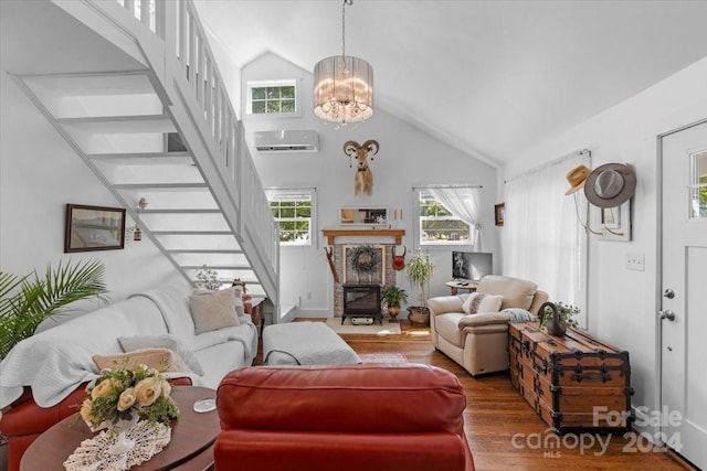 living room with high vaulted ceiling, a chandelier, a wall unit AC, and hardwood / wood-style flooring