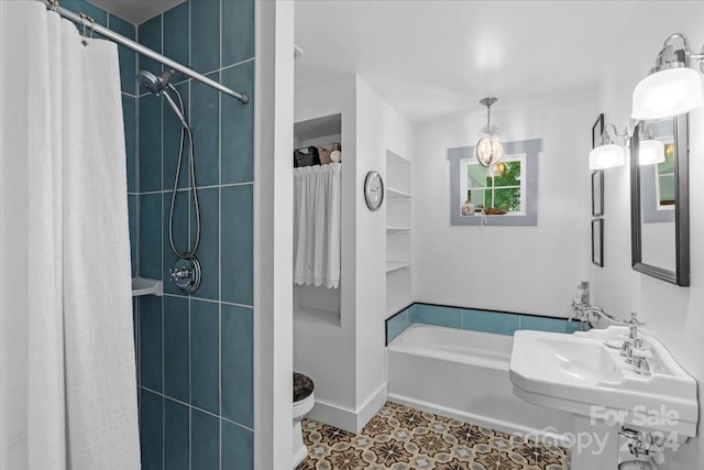 full bathroom with toilet, shower / bath combo with shower curtain, sink, and tile patterned floors