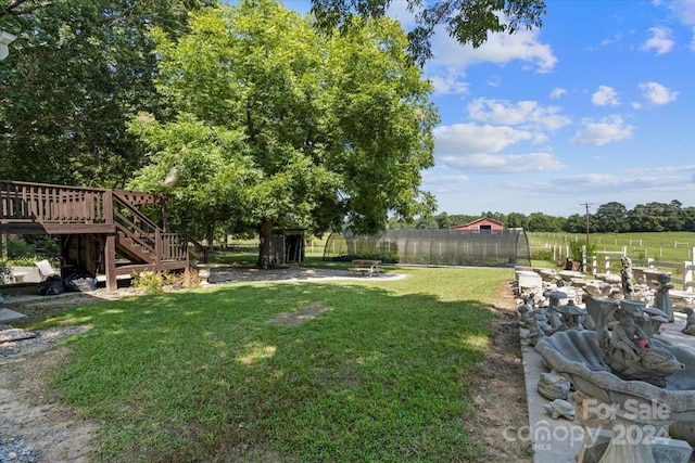 view of yard with a deck and a rural view