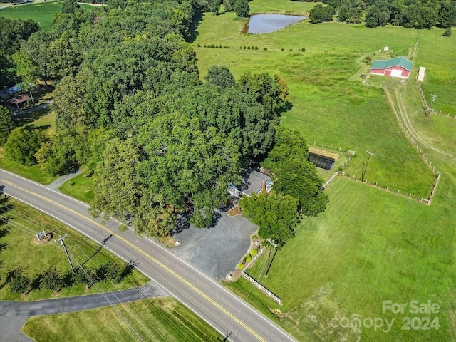 birds eye view of property featuring a water view and a rural view