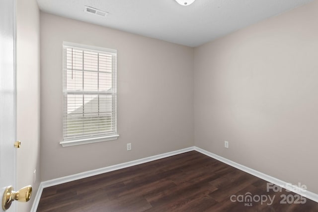 spare room featuring dark wood-type flooring