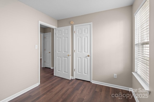 unfurnished bedroom featuring dark wood-type flooring