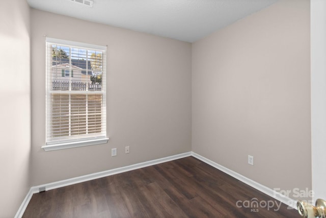 unfurnished room featuring dark hardwood / wood-style flooring