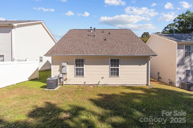 back of property with a lawn and cooling unit