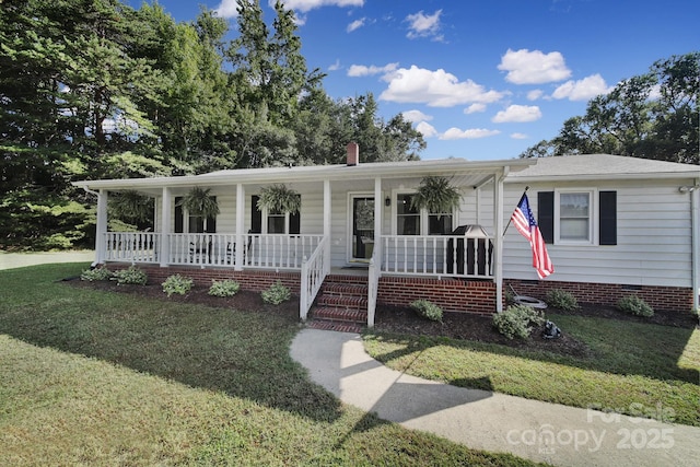 view of front of home with a porch and a front yard