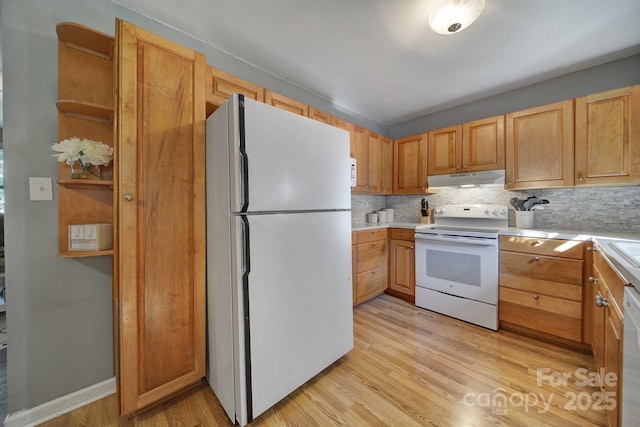 kitchen featuring tasteful backsplash, light brown cabinetry, white appliances, and light wood-type flooring