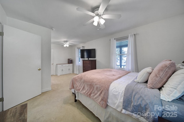 bedroom featuring ceiling fan and light carpet