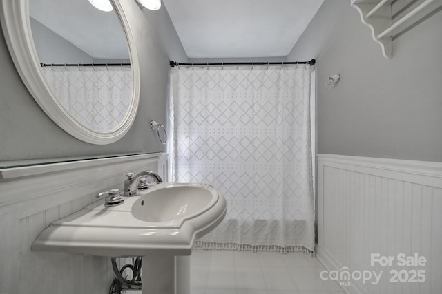 bathroom with tile patterned floors, sink, and a shower with shower curtain