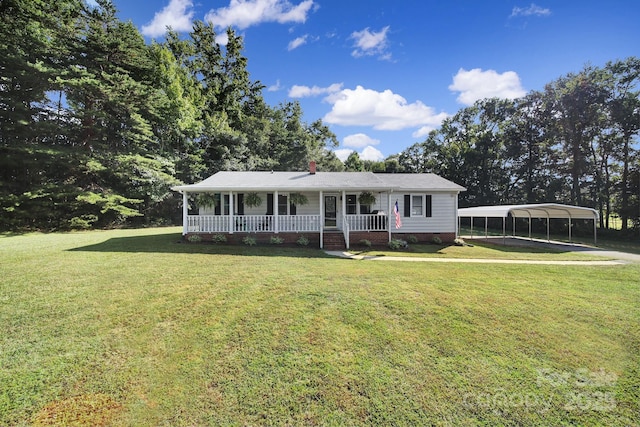 view of front of house with a carport, covered porch, and a front yard