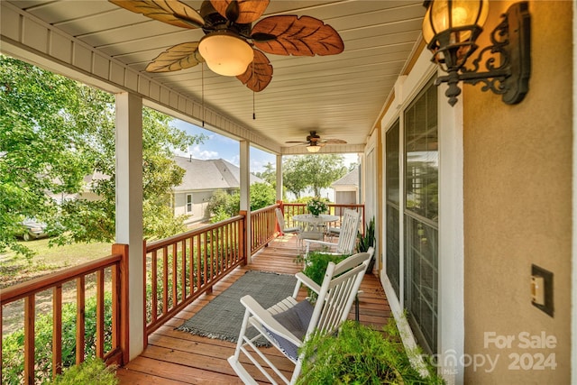 wooden deck with covered porch and a ceiling fan