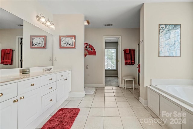 bathroom featuring vanity, a bathing tub, and tile patterned floors