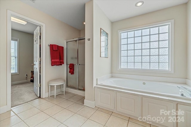 bathroom with separate shower and tub and tile patterned floors