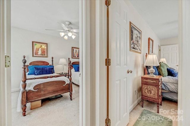 bedroom featuring ceiling fan and light carpet