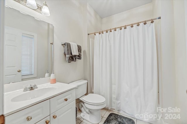 bathroom with tile patterned flooring, toilet, walk in shower, and vanity